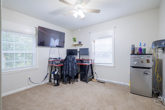 carpeted office space featuring ceiling fan