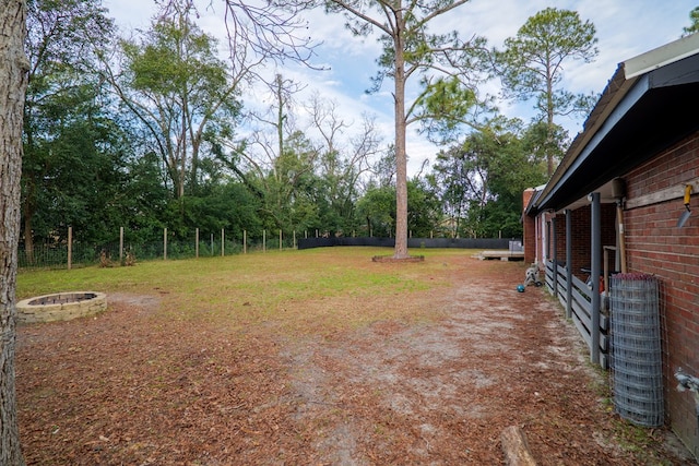 view of yard featuring an outdoor fire pit and central AC unit