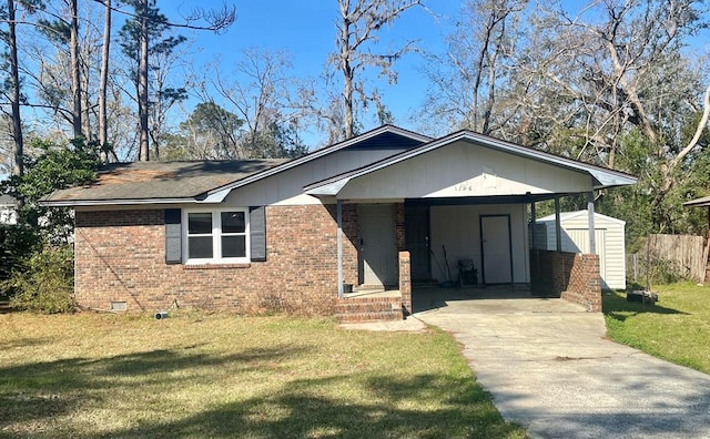 view of front of property featuring a storage shed, concrete driveway, brick siding, and crawl space