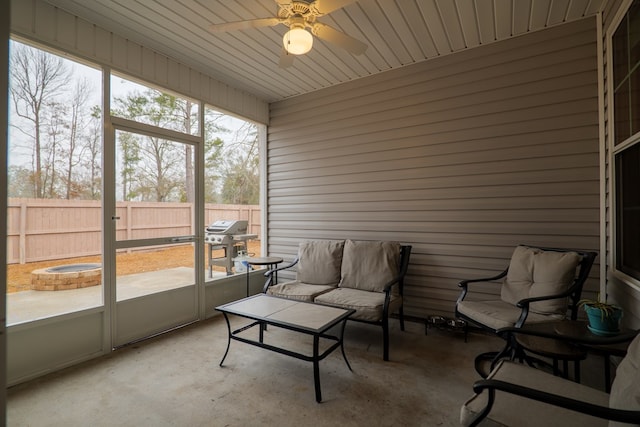 sunroom featuring ceiling fan