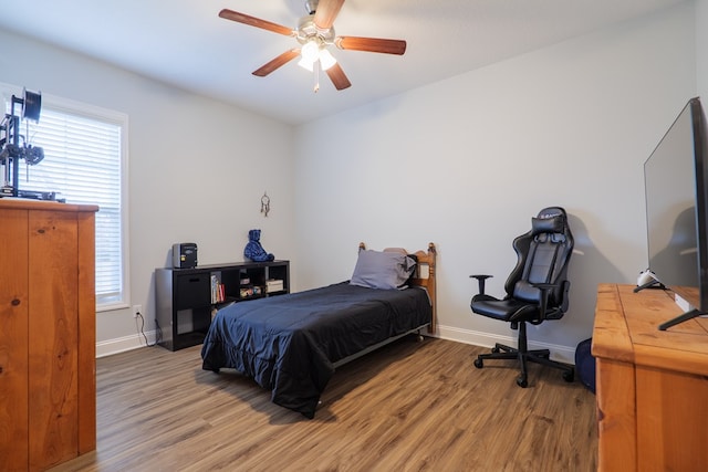 bedroom featuring hardwood / wood-style flooring and ceiling fan