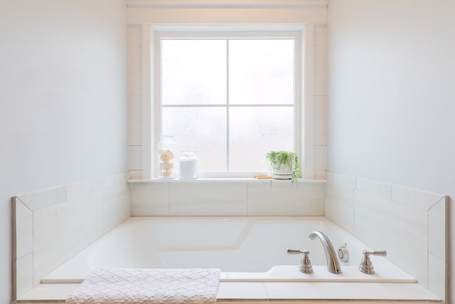 bathroom featuring tiled bath