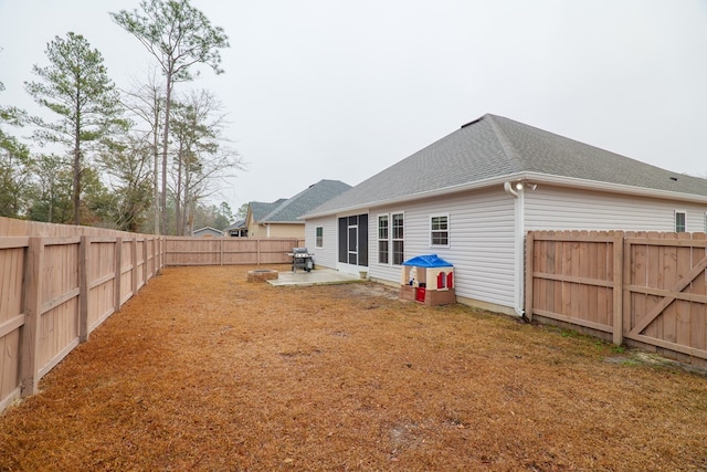 rear view of house featuring a patio and a lawn