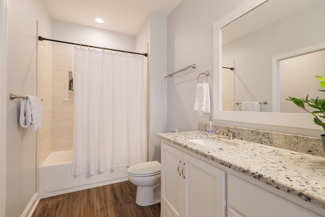 full bathroom featuring vanity, wood-type flooring, shower / bath combination with curtain, and toilet