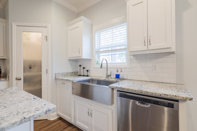 kitchen featuring light stone countertops, sink, stainless steel dishwasher, and white cabinets