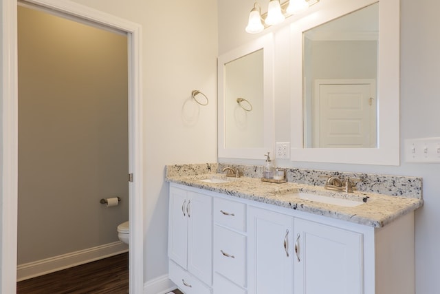 bathroom with vanity, hardwood / wood-style floors, and toilet