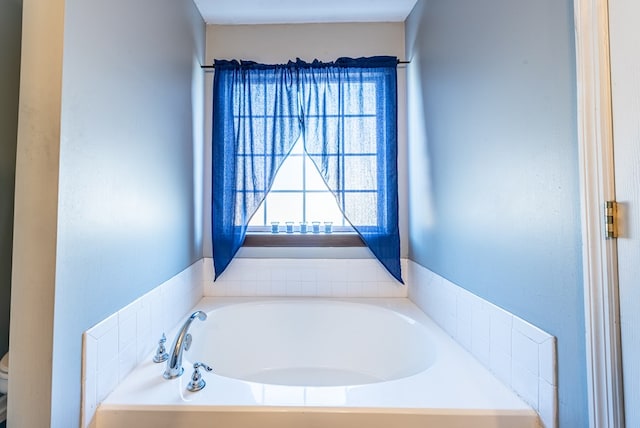 bathroom with toilet and a bath