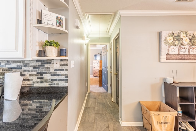 hallway featuring ornamental molding