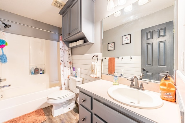 full bathroom featuring shower / tub combo, vanity, hardwood / wood-style flooring, and toilet