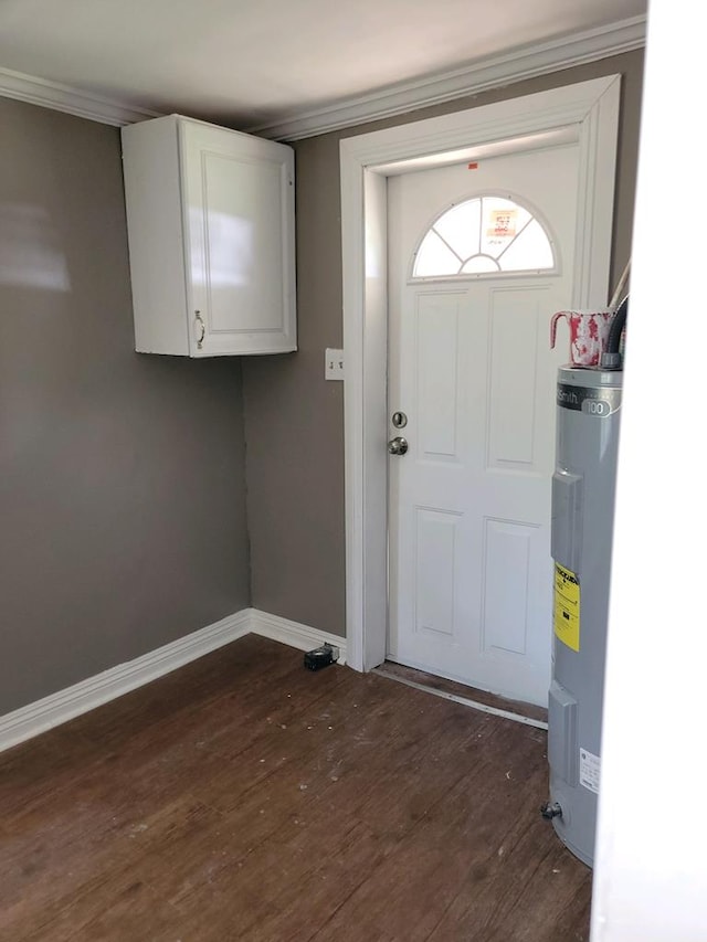 doorway with dark hardwood / wood-style floors, crown molding, and water heater