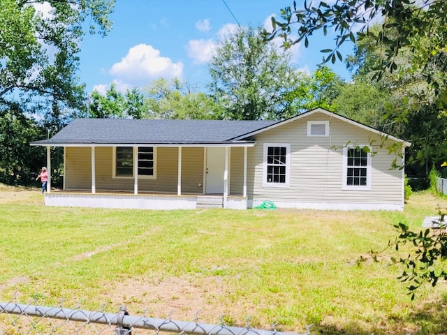 rear view of house featuring a porch and a yard