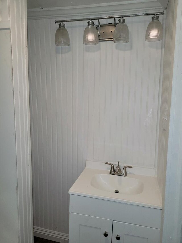 bathroom with wooden walls and vanity