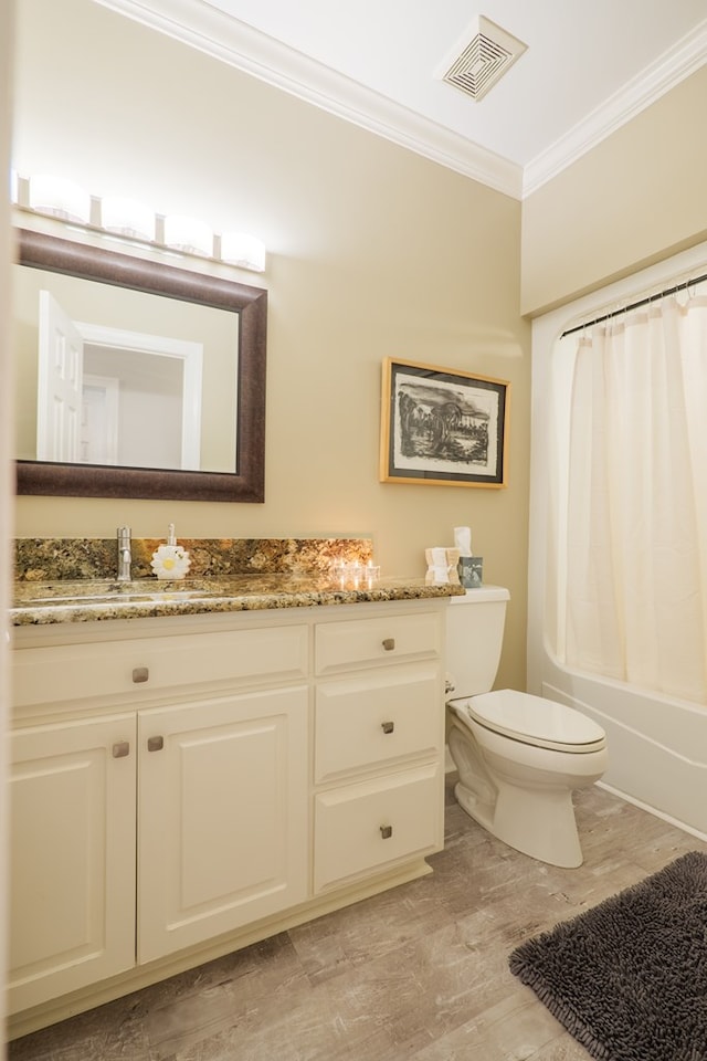 bathroom with visible vents, toilet, ornamental molding, shower / bathtub combination with curtain, and vanity