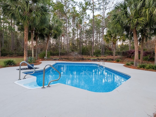 outdoor pool featuring a fenced backyard and a patio