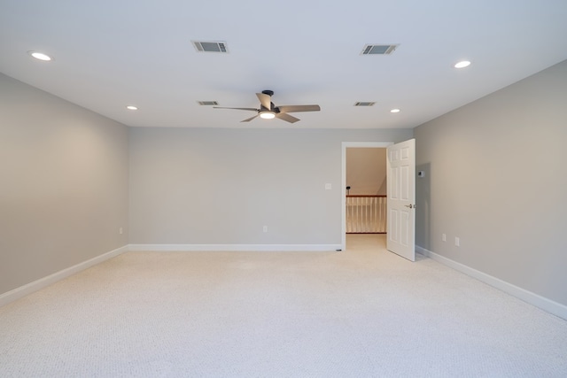 spare room with recessed lighting, visible vents, and baseboards