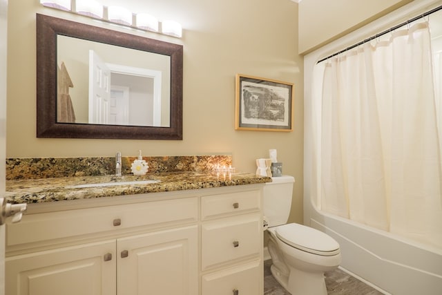 bathroom featuring shower / tub combo, vanity, and toilet