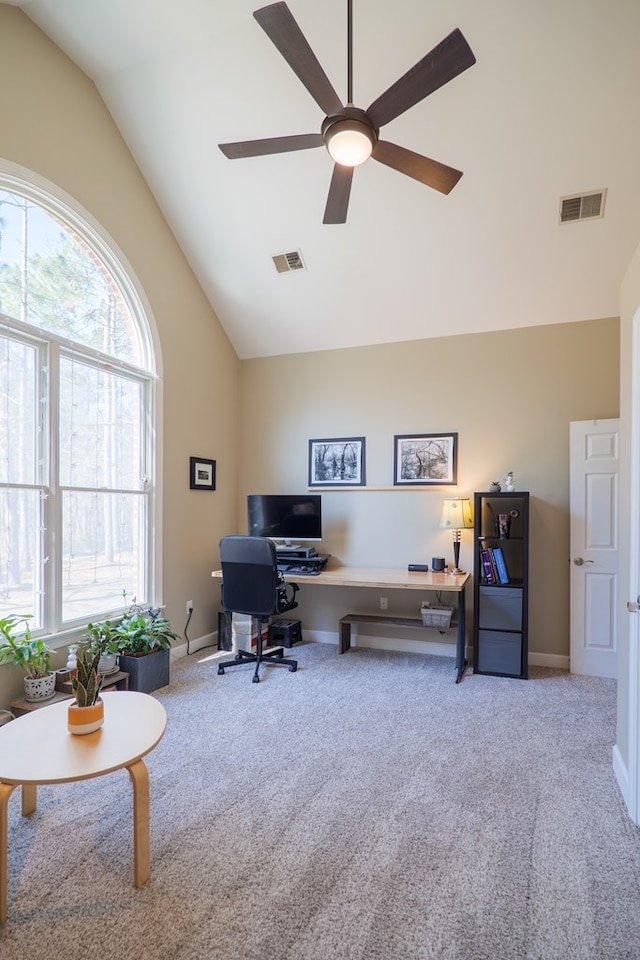 office area with baseboards, visible vents, a ceiling fan, and light colored carpet