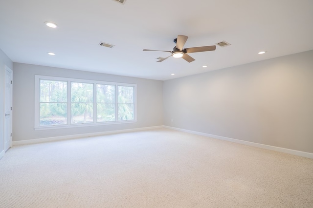 spare room with recessed lighting, visible vents, light carpet, ceiling fan, and baseboards