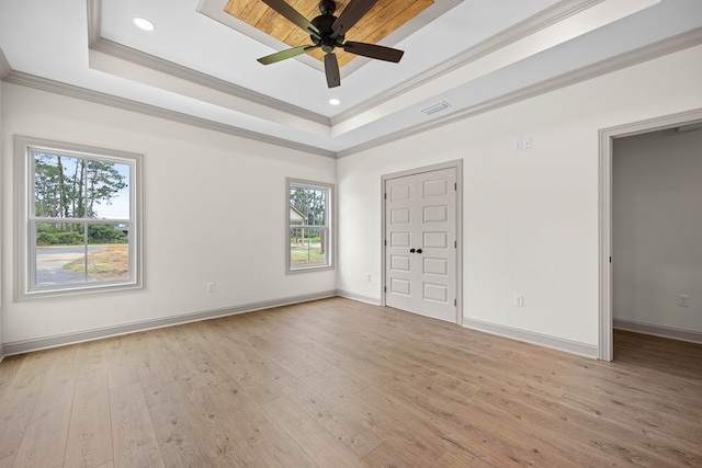 2204 N Oak St, Valdosta, GA 31602 - unfurnished bedroom featuring a tray ceiling, multiple windows, light wood-type flooring, ornamental molding, and recessed lighting