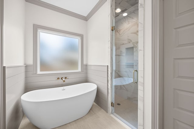 2204 N Oak St, Valdosta, GA 31602 - bathroom featuring a freestanding tub, a marble finish shower, crown molding, and wainscoting