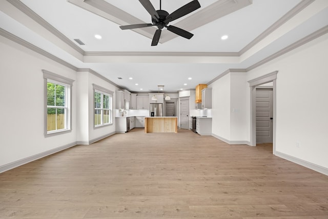 2204 N Oak St, Valdosta, GA 31602 - unfurnished living room with crown molding, a raised ceiling, recessed lighting, light wood finished floors, and a ceiling fan