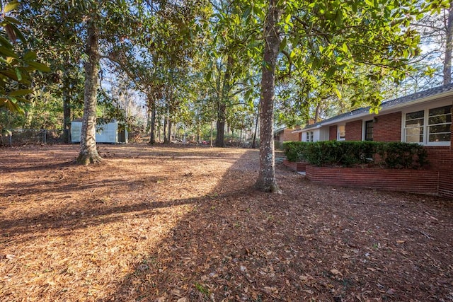 2205 Park Ln, Valdosta, GA 31602 - view of yard featuring a storage shed, fence, and an outdoor structure