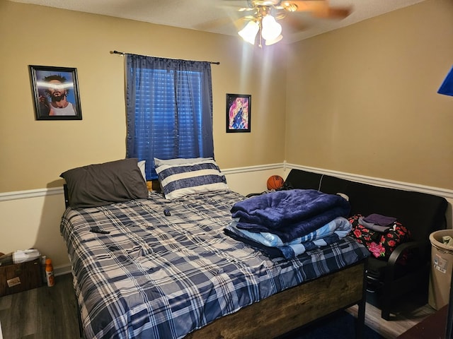 bedroom featuring baseboards, ceiling fan, and wood finished floors