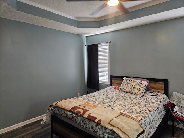 bedroom featuring ceiling fan, a textured ceiling, ornamental molding, baseboards, and dark wood-style floors