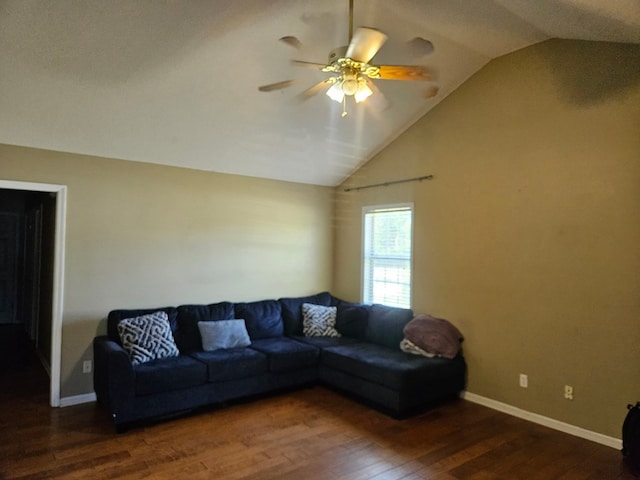 living area with baseboards, ceiling fan, wood finished floors, and vaulted ceiling