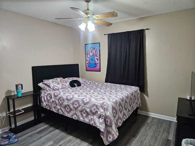 bedroom featuring baseboards, a ceiling fan, and wood finished floors