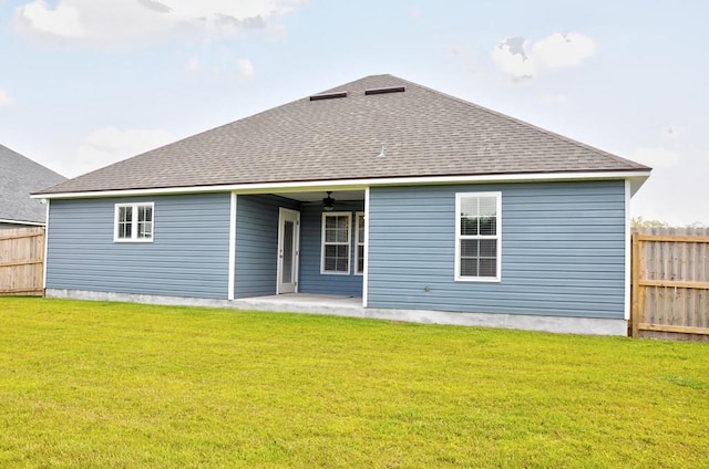 3968 Lu Ln, Hahira, GA 31632 - back of property with a ceiling fan, a shingled roof, fence, and a lawn