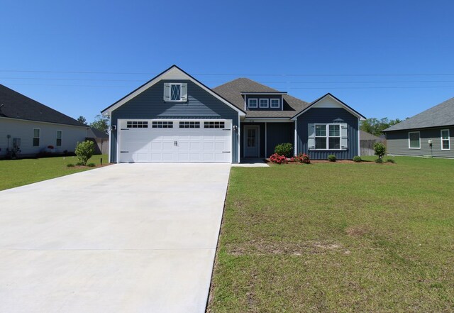3968 Lu Ln, Hahira, GA 31632 - view of front of home featuring an attached garage, roof with shingles, driveway, and a front yard
