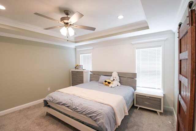 3968 Lu Ln, Hahira, GA 31632 - bedroom featuring baseboards, a raised ceiling, a barn door, ornamental molding, and carpet floors