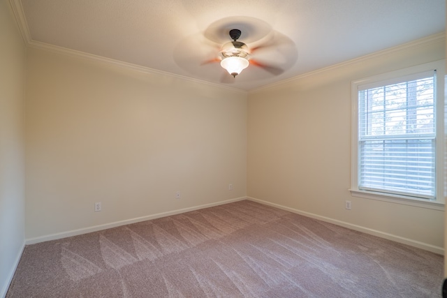 empty room with light carpet, baseboards, a ceiling fan, and crown molding