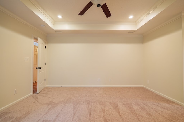 spare room with a tray ceiling, carpet flooring, and recessed lighting