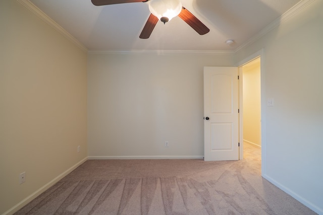 unfurnished room with crown molding, ceiling fan, baseboards, and light colored carpet