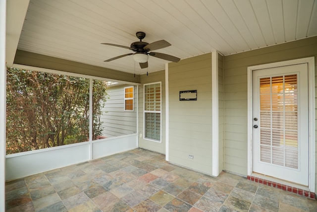 unfurnished sunroom with wood ceiling and ceiling fan