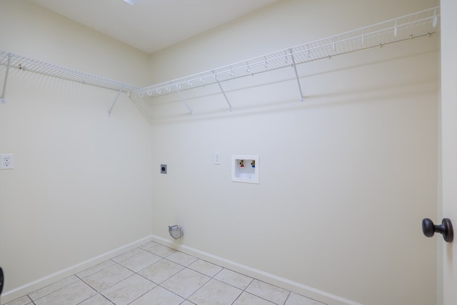 laundry room featuring light tile patterned floors, hookup for a washing machine, hookup for an electric dryer, laundry area, and baseboards