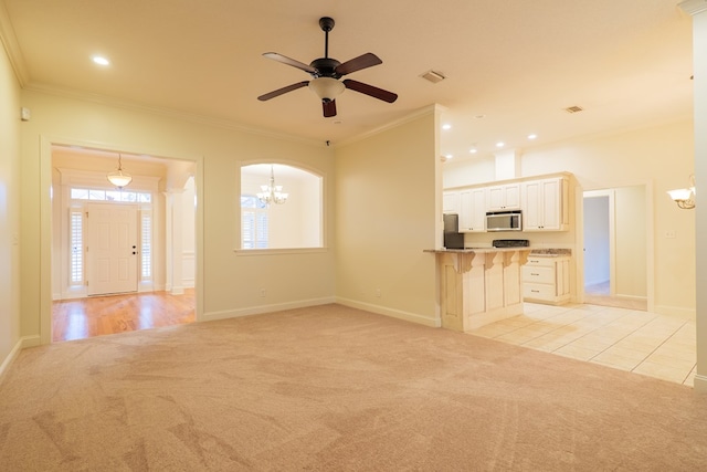 unfurnished living room featuring light colored carpet, crown molding, and visible vents