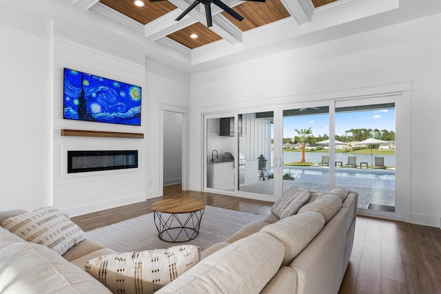 living room with hardwood / wood-style floors, coffered ceiling, a fireplace, beamed ceiling, and wood ceiling