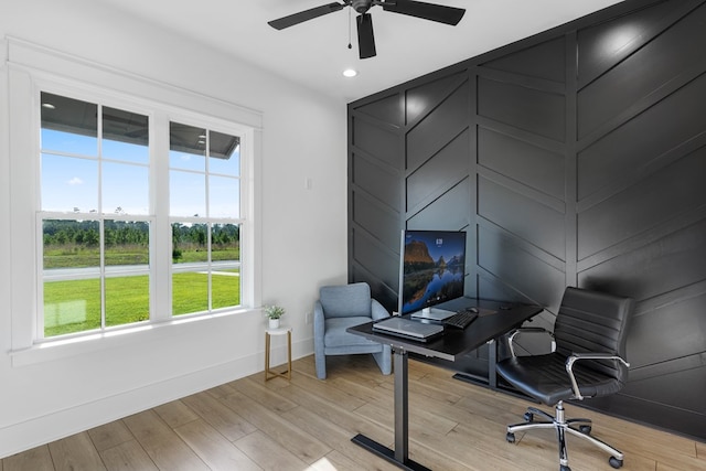 office featuring ceiling fan, a healthy amount of sunlight, and light hardwood / wood-style floors