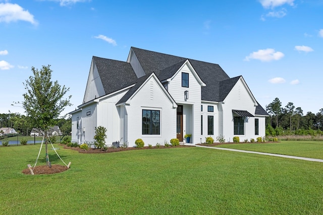 modern inspired farmhouse featuring a front lawn