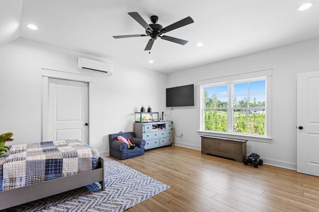 bedroom with ceiling fan, lofted ceiling, an AC wall unit, and light hardwood / wood-style flooring