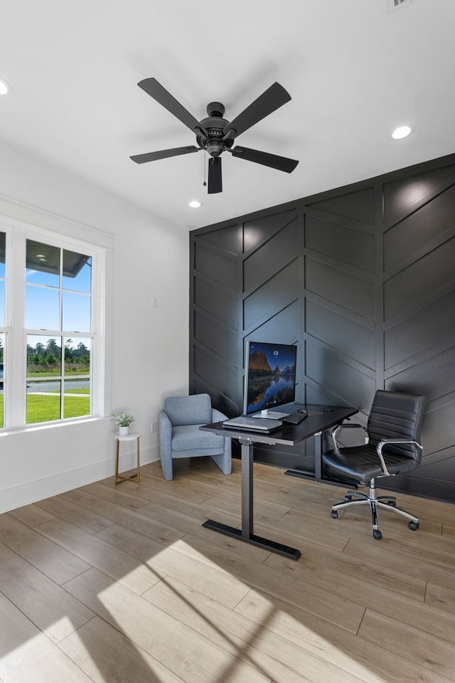 home office featuring ceiling fan and light hardwood / wood-style flooring