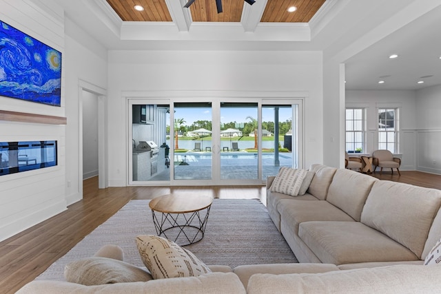 living room featuring wood ceiling, ornamental molding, and hardwood / wood-style flooring