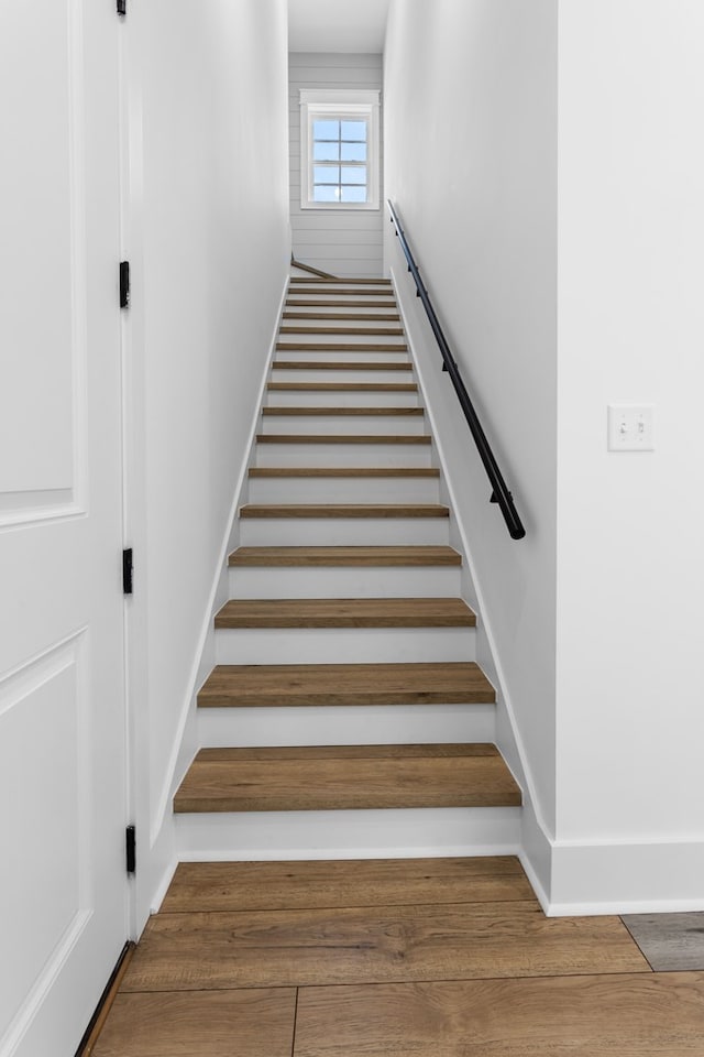 stairway with hardwood / wood-style floors