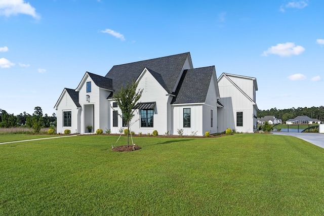 modern inspired farmhouse featuring a front lawn