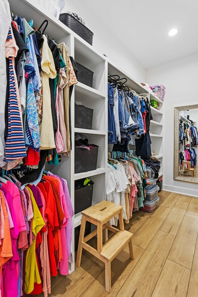 walk in closet with hardwood / wood-style floors