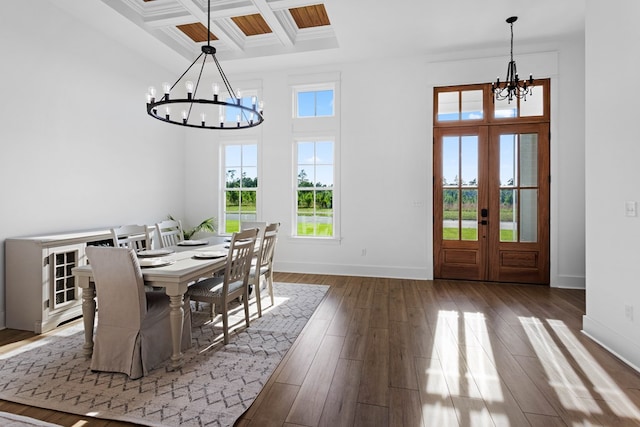 dining area featuring french doors, coffered ceiling, dark hardwood / wood-style flooring, beamed ceiling, and a notable chandelier