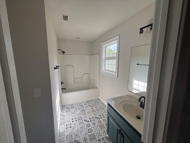 909 E Moore St, Valdosta, GA 31601 - bathroom featuring vanity,  shower combination, baseboards, and tile patterned floors